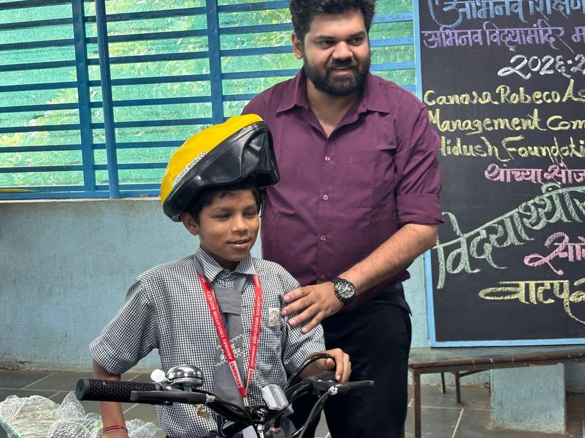 A helmet being fitted for a student
