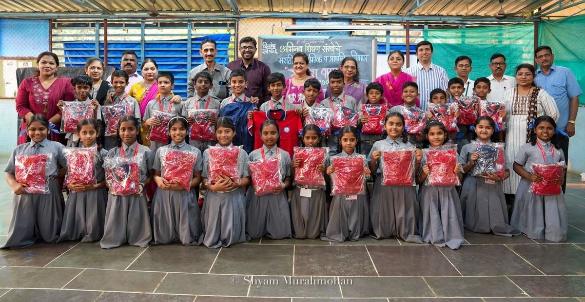 Students holding their new uniforms