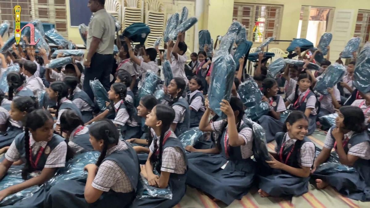 Students in the school hall with their new bags